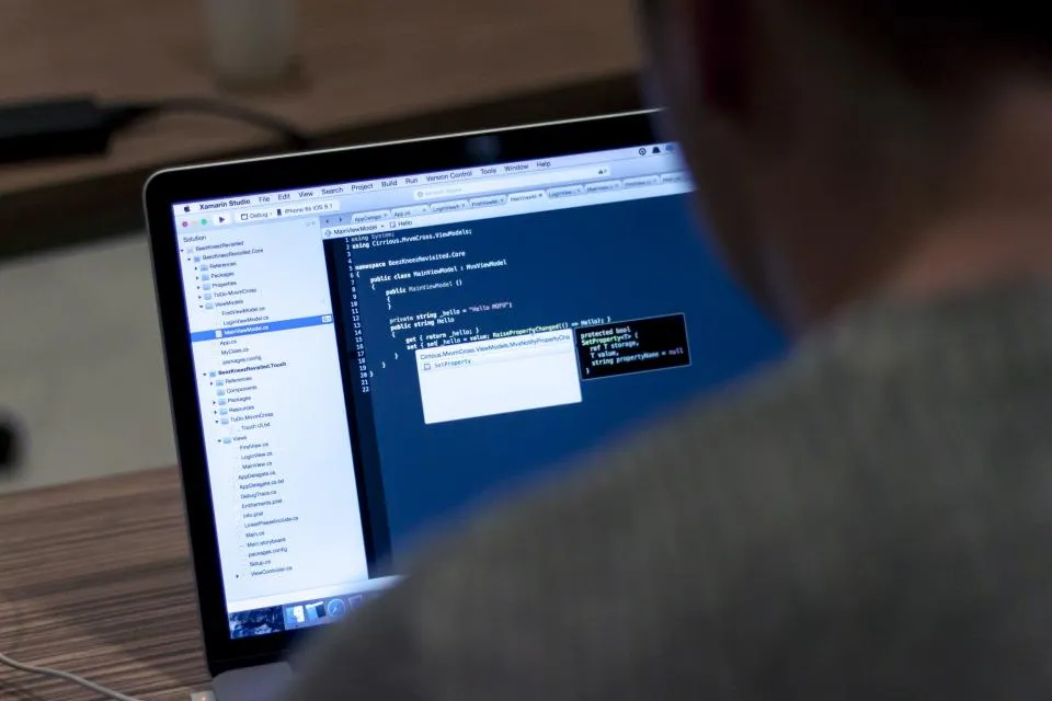 Developer reading code on a laptop