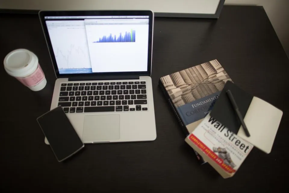 Laptop showing a market chart next to a smartphone