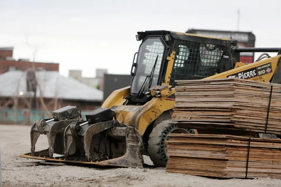 Loader moving stacked timber in a wholesale yard